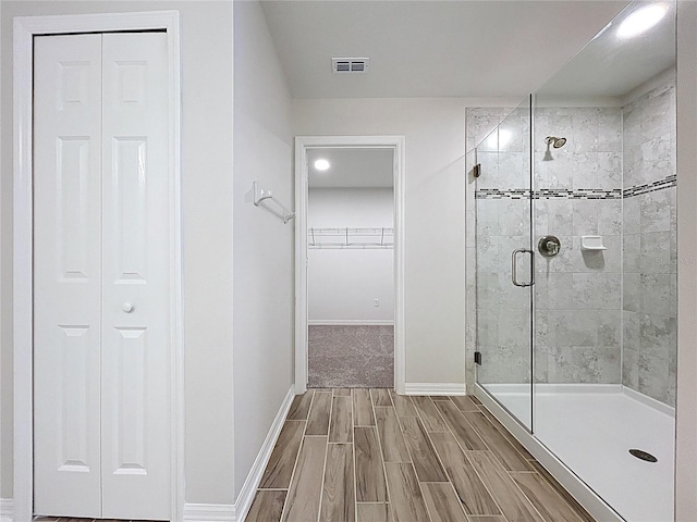 3063 Marine Grass Dr, Wimauma, FL 33598 - bathroom with a shower stall, baseboards, wood tiled floors, recessed lighting, and a spacious closet