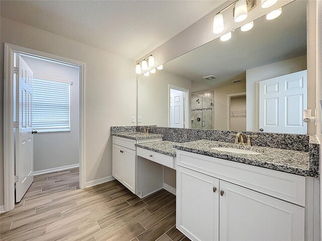 3063 Marine Grass Dr, Wimauma, FL 33598 - full bath featuring a shower stall, two vanities, wood finished floors, and baseboards