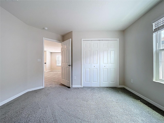 3063 Marine Grass Dr, Wimauma, FL 33598 - unfurnished bedroom featuring carpet flooring, baseboards, and a closet