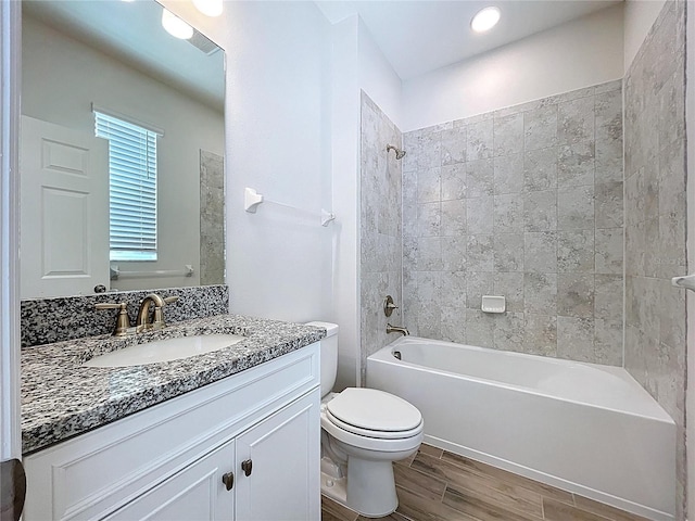 3063 Marine Grass Dr, Wimauma, FL 33598 - bathroom with vanity, wood finished floors, toilet, and washtub / shower combination