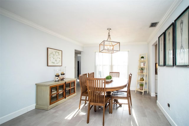 11071 141st St, Largo, FL 33774 - dining space featuring a chandelier, crown molding, and baseboards