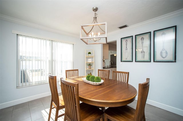 11071 141st St, Largo, FL 33774 - dining space featuring a chandelier, baseboards, and crown molding