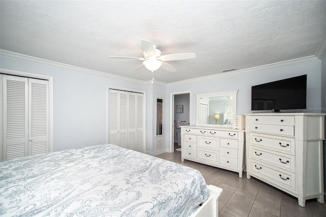 11071 141st St, Largo, FL 33774 - bedroom featuring two closets, ornamental molding, and a ceiling fan