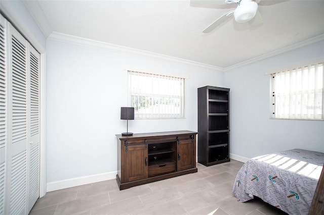 11071 141st St, Largo, FL 33774 - bedroom with ornamental molding, multiple windows, a closet, baseboards, and light tile patterned floors