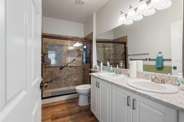13200 W Newberry Rd Unit B8, Newberry, FL 32669 - bathroom featuring toilet, double vanity, a shower stall, and wood finished floors