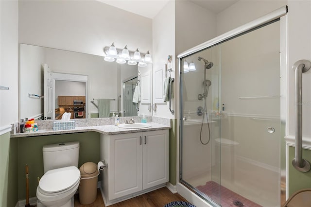 13200 W Newberry Rd Unit B8, Newberry, FL 32669 - bathroom featuring a shower stall, toilet, vanity, and wood finished floors