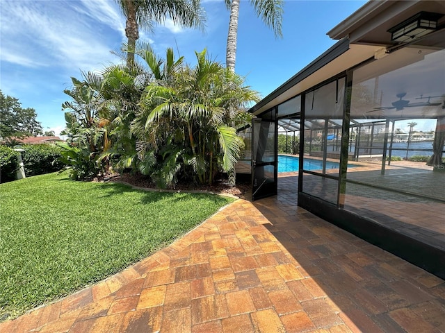 3654 Corsair Ct, New Port Richey, FL 34652 - view of grassy yard featuring an outdoor pool, a patio area, a lanai, and ceiling fan