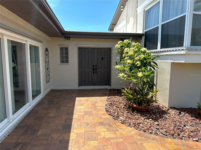 3654 Corsair Ct, New Port Richey, FL 34652 - doorway to property featuring stucco siding