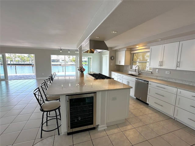 3654 Corsair Ct, New Port Richey, FL 34652 - kitchen with wine cooler, appliances with stainless steel finishes, a sink, a breakfast bar, and light tile patterned floors