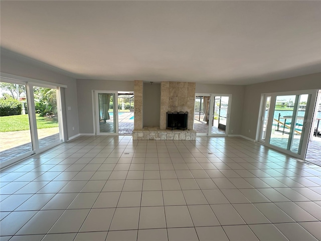 3654 Corsair Ct, New Port Richey, FL 34652 - unfurnished living room featuring plenty of natural light, baseboards, and light tile patterned floors