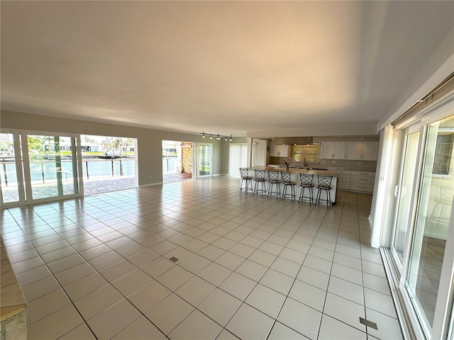 3654 Corsair Ct, New Port Richey, FL 34652 - spare room with light tile patterned floors and track lighting