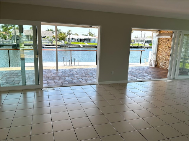 3654 Corsair Ct, New Port Richey, FL 34652 - spare room with a water view, tile patterned flooring, and baseboards