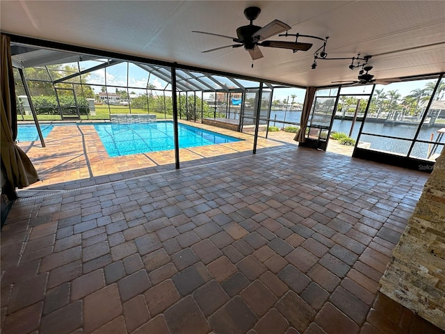 3654 Corsair Ct, New Port Richey, FL 34652 - swimming pool with ceiling fan, a water view, glass enclosure, and a patio