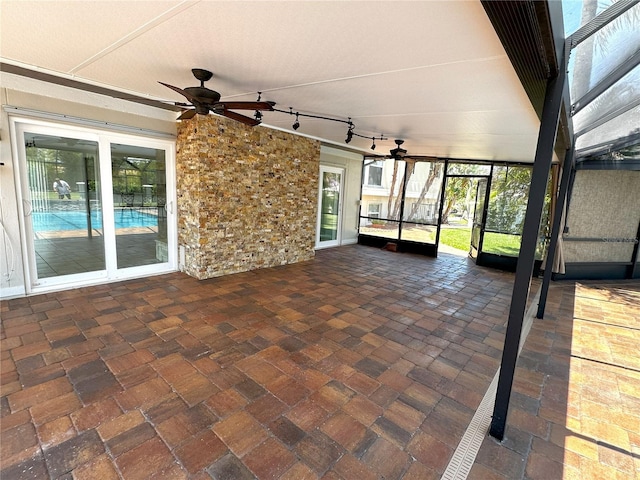 3654 Corsair Ct, New Port Richey, FL 34652 - unfurnished sunroom featuring a ceiling fan and rail lighting