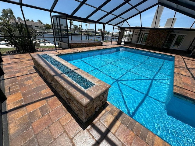 3654 Corsair Ct, New Port Richey, FL 34652 - swimming pool featuring a patio, a water view, and glass enclosure