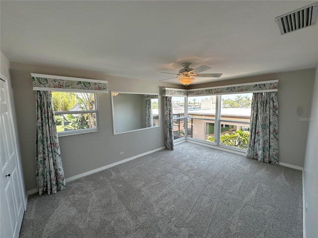 3654 Corsair Ct, New Port Richey, FL 34652 - spare room featuring baseboards, healthy amount of natural light, and carpet