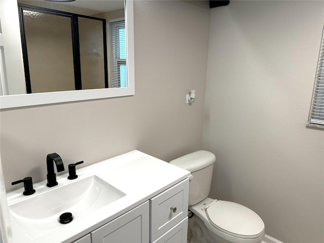 3654 Corsair Ct, New Port Richey, FL 34652 - bathroom featuring toilet, vanity, a shower stall, and baseboards