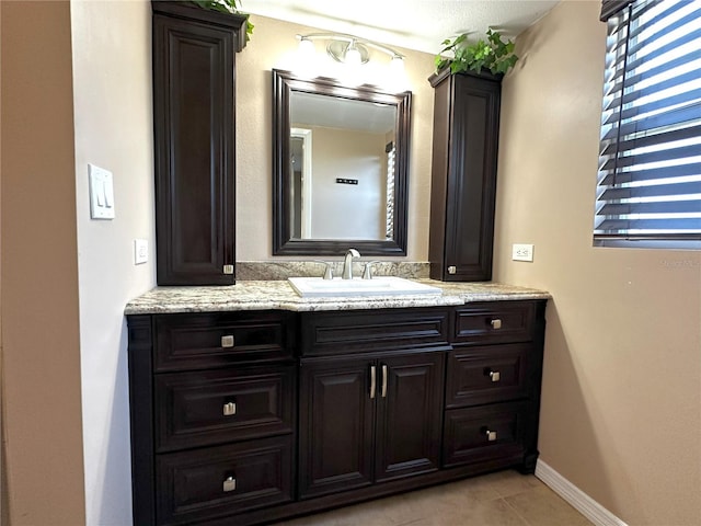 3654 Corsair Ct, New Port Richey, FL 34652 - bathroom featuring vanity, tile patterned flooring, and baseboards
