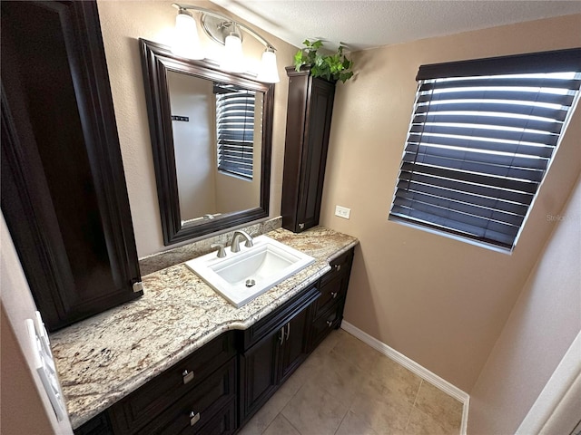 3654 Corsair Ct, New Port Richey, FL 34652 - bathroom featuring vanity, a textured ceiling, baseboards, and tile patterned floors