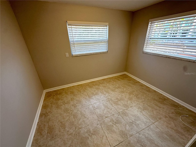 3654 Corsair Ct, New Port Richey, FL 34652 - spare room with baseboards and tile patterned floors