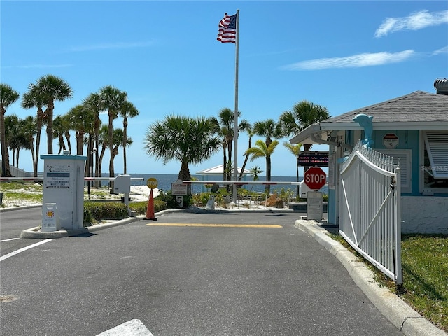 3654 Corsair Ct, New Port Richey, FL 34652 - view of asphalt street with traffic signs, a gated entry, and curbs