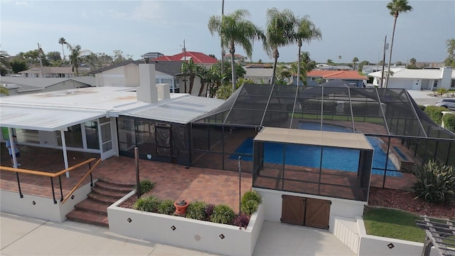 3654 Corsair Ct, New Port Richey, FL 34652 - back of house featuring a residential view, an outdoor pool, and a patio area
