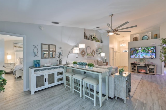 214 Lookout Dr, Apollo Beach, FL 33572 - living room with lofted ceiling, ceiling fan, and wood finished floors
