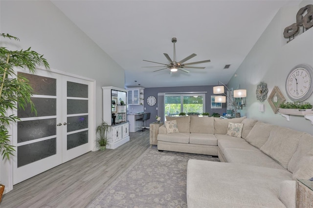214 Lookout Dr, Apollo Beach, FL 33572 - living room with wood finished floors, ceiling fan, french doors, and high vaulted ceiling