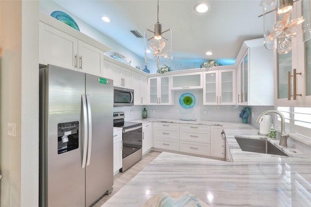 214 Lookout Dr, Apollo Beach, FL 33572 - kitchen with appliances with stainless steel finishes, a sink, light stone counters, white cabinetry, and glass insert cabinets