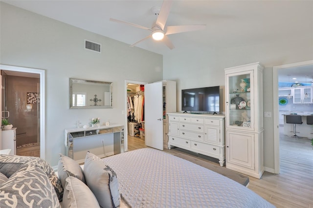 214 Lookout Dr, Apollo Beach, FL 33572 - bedroom featuring a spacious closet, light wood-type flooring, ensuite bath, and a closet