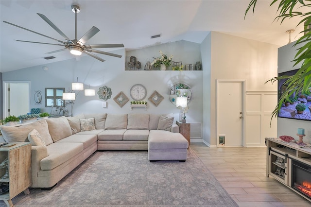 214 Lookout Dr, Apollo Beach, FL 33572 - living room with vaulted ceiling, wood finished floors, and a ceiling fan