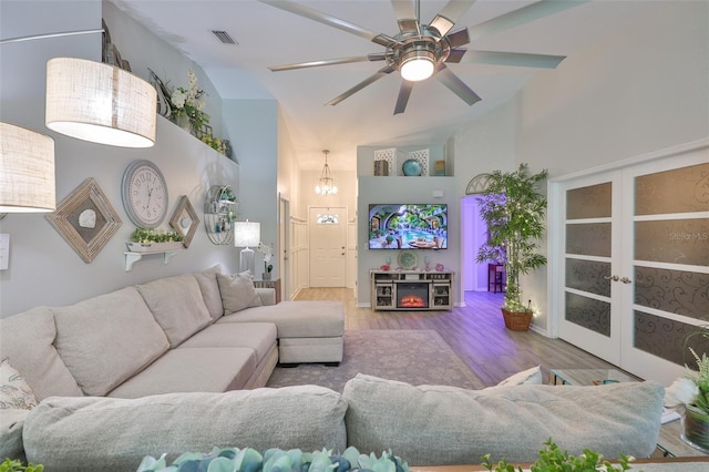 214 Lookout Dr, Apollo Beach, FL 33572 - living area with high vaulted ceiling, wood finished floors, ceiling fan, a chandelier, and french doors