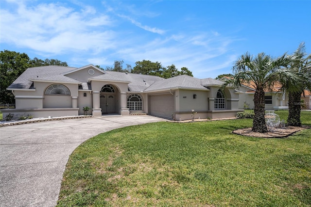 14181 Cornewall Ln, Spring Hill, FL 34609 - mediterranean / spanish home featuring stucco siding, an attached garage, concrete driveway, and a front lawn