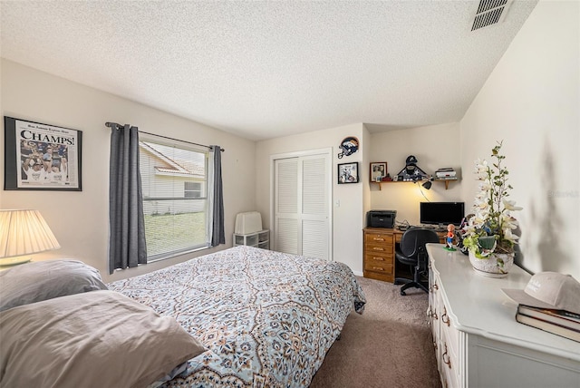 14181 Cornewall Ln, Spring Hill, FL 34609 - bedroom with carpet, a closet, a textured ceiling, and a desk