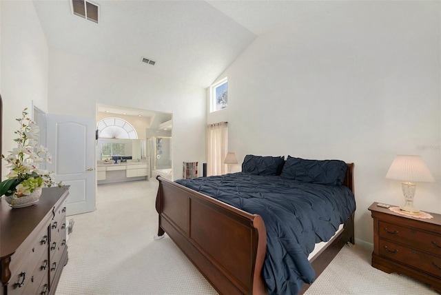 14181 Cornewall Ln, Spring Hill, FL 34609 - bedroom featuring light carpet, high vaulted ceiling, and ensuite bath