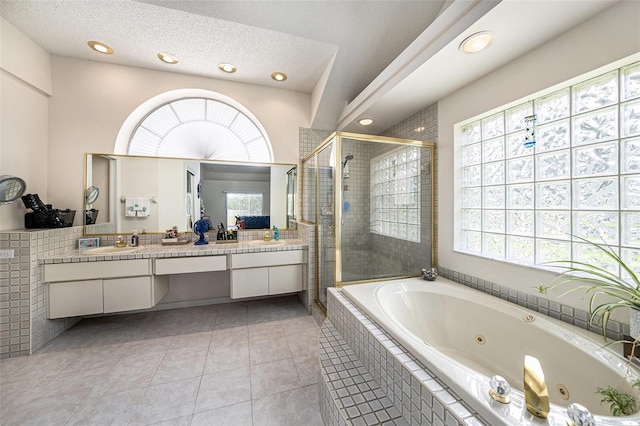 14181 Cornewall Ln, Spring Hill, FL 34609 - bathroom with double vanity, a jetted tub, a shower stall, recessed lighting, and tile patterned floors