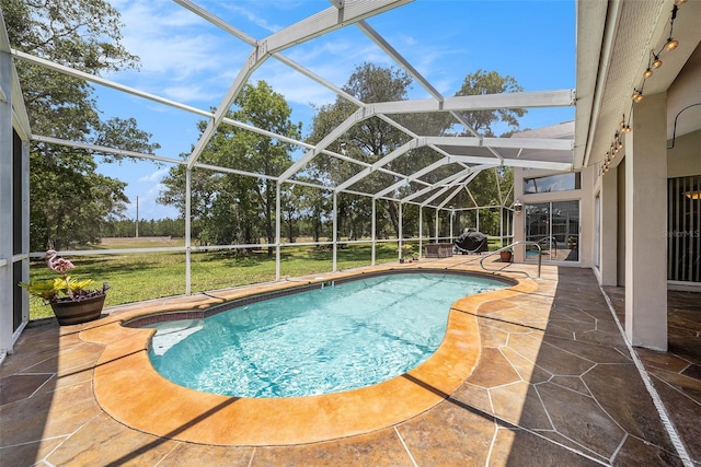 14181 Cornewall Ln, Spring Hill, FL 34609 - outdoor pool with a patio area, a lawn, and glass enclosure