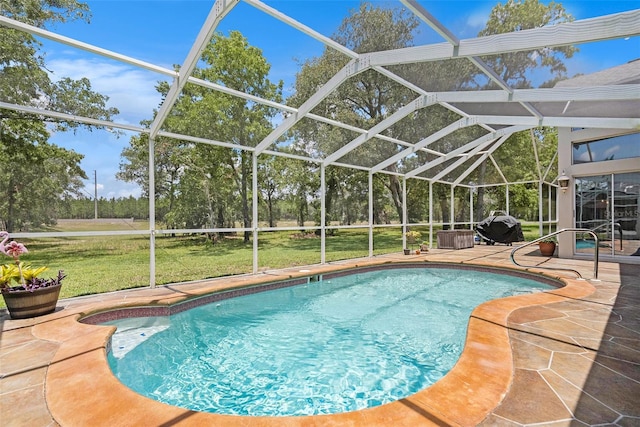 14181 Cornewall Ln, Spring Hill, FL 34609 - outdoor pool featuring a patio, a lawn, and glass enclosure
