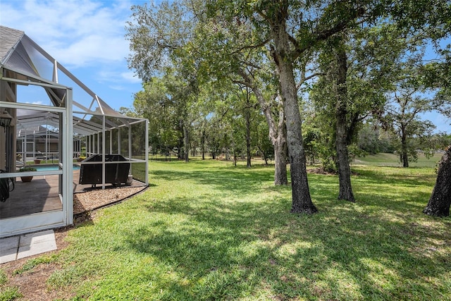 14181 Cornewall Ln, Spring Hill, FL 34609 - view of green lawn featuring an outdoor pool and glass enclosure