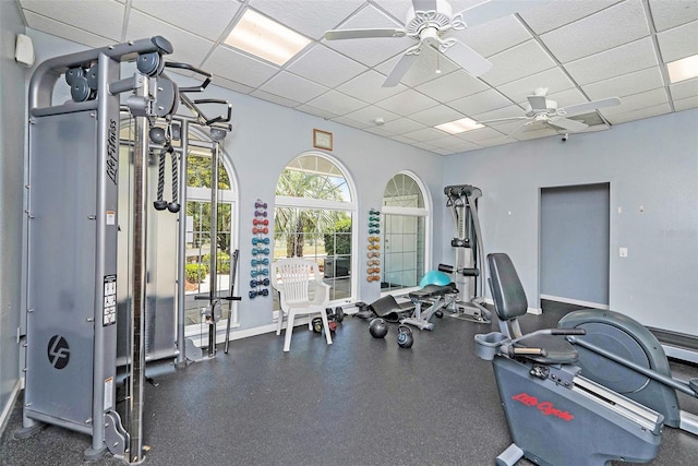 14181 Cornewall Ln, Spring Hill, FL 34609 - exercise room featuring a paneled ceiling, ceiling fan, and baseboards