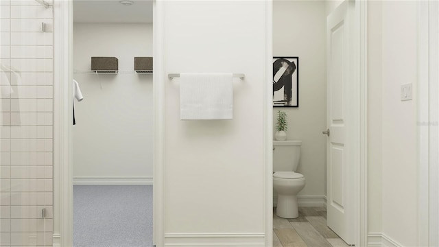 11733 E 71st Ter, Palmetto, FL 34221 - full bath with toilet, a tile shower, and baseboards