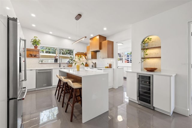 310 55th Ave S, Saint Petersburg, FL 33705 - kitchen with beverage cooler, stainless steel appliances, open shelves, backsplash, and recessed lighting