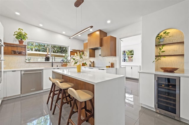 310 55th Ave S, Saint Petersburg, FL 33705 - kitchen featuring wine cooler, stainless steel dishwasher, open shelves, a sink, and recessed lighting