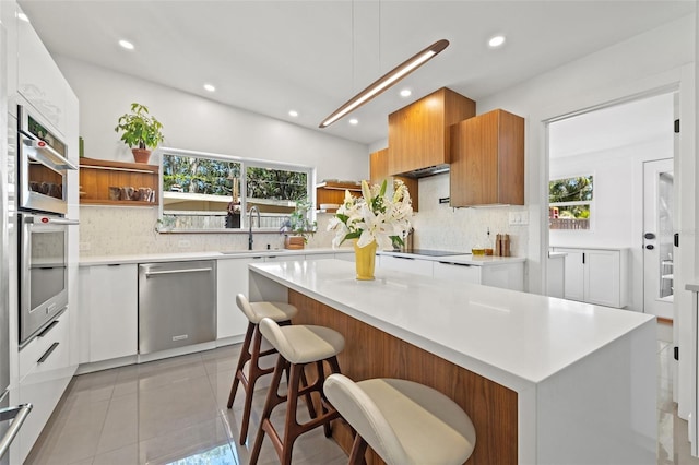 310 55th Ave S, Saint Petersburg, FL 33705 - kitchen with appliances with stainless steel finishes, open shelves, a sink, recessed lighting, and light countertops