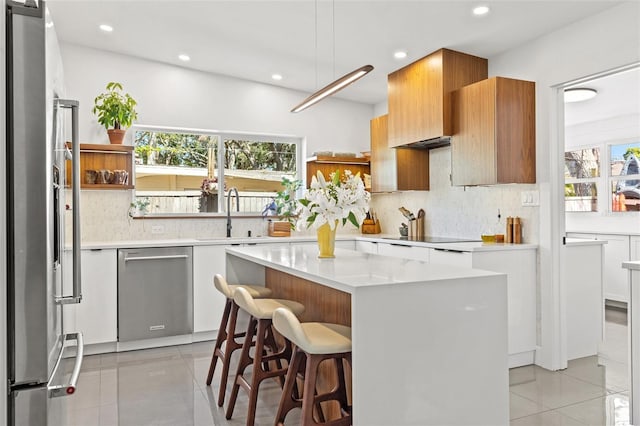 310 55th Ave S, Saint Petersburg, FL 33705 - kitchen with stainless steel appliances, open shelves, a sink, recessed lighting, and healthy amount of natural light