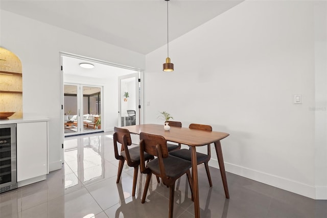 310 55th Ave S, Saint Petersburg, FL 33705 - dining room featuring tile patterned flooring, baseboards, and wine cooler