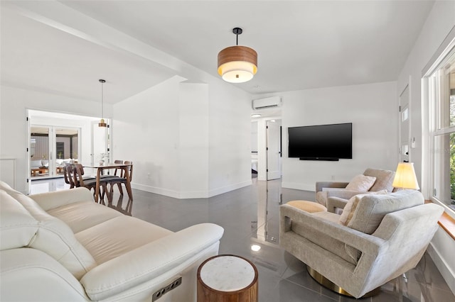 310 55th Ave S, Saint Petersburg, FL 33705 - living room featuring a wall mounted AC and baseboards