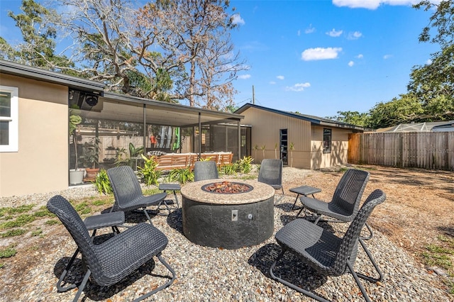 310 55th Ave S, Saint Petersburg, FL 33705 - view of patio featuring an outdoor fire pit and a sunroom
