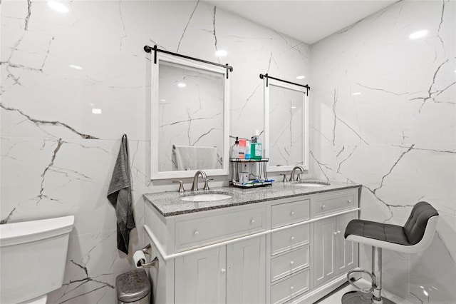 9314 Alta Sol Way, New Port Richey, FL 34655 - bathroom with tile walls, double vanity, and toilet