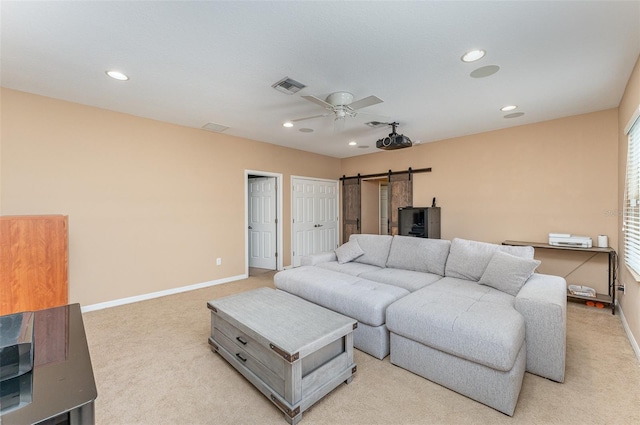 11206 Coventry Grove Cir, Lithia, FL 33547 - living room with light colored carpet, a barn door, a ceiling fan, baseboards, and recessed lighting